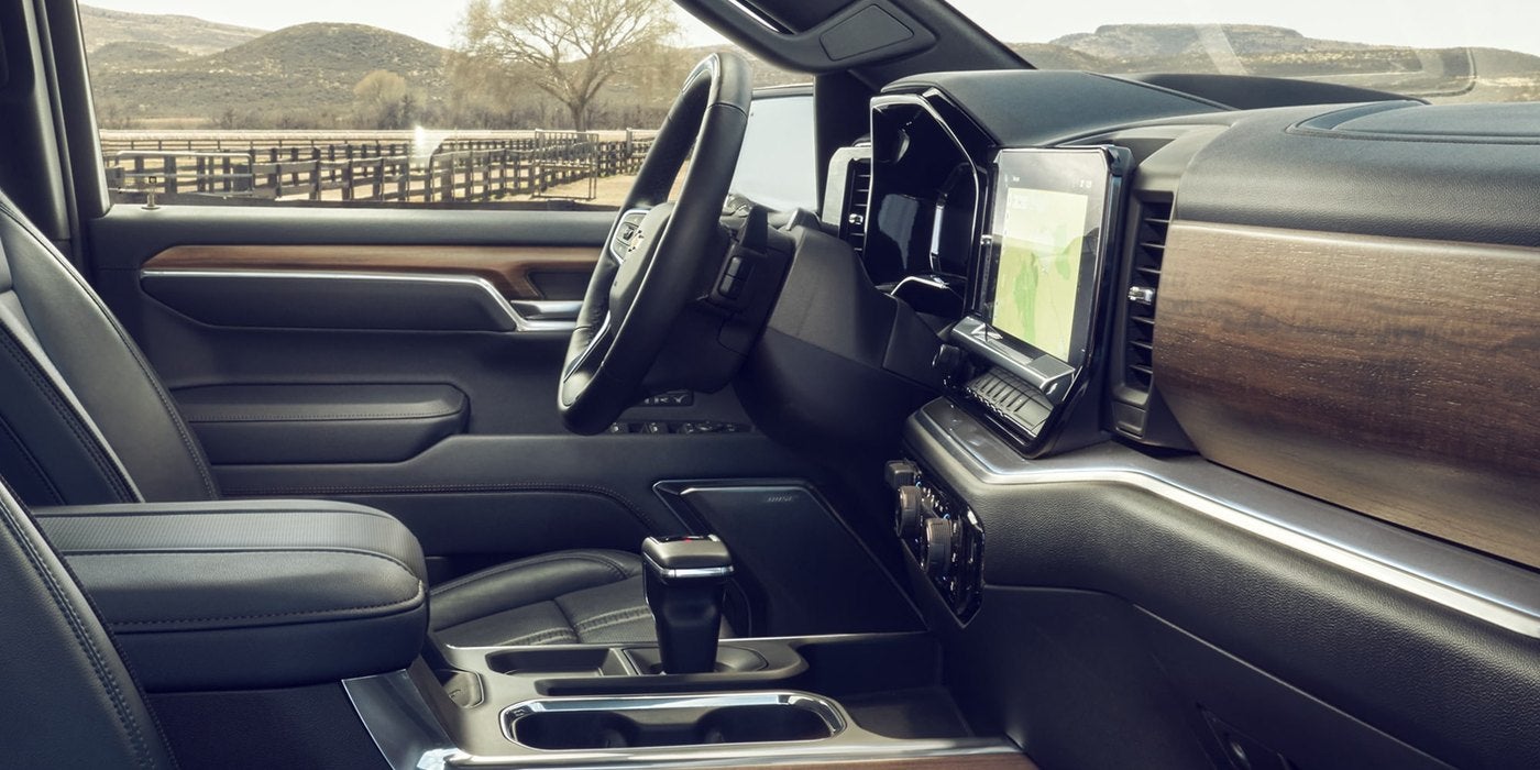 Silverado 1500 cabin with leather seats, wood trim dash and center touchscreen