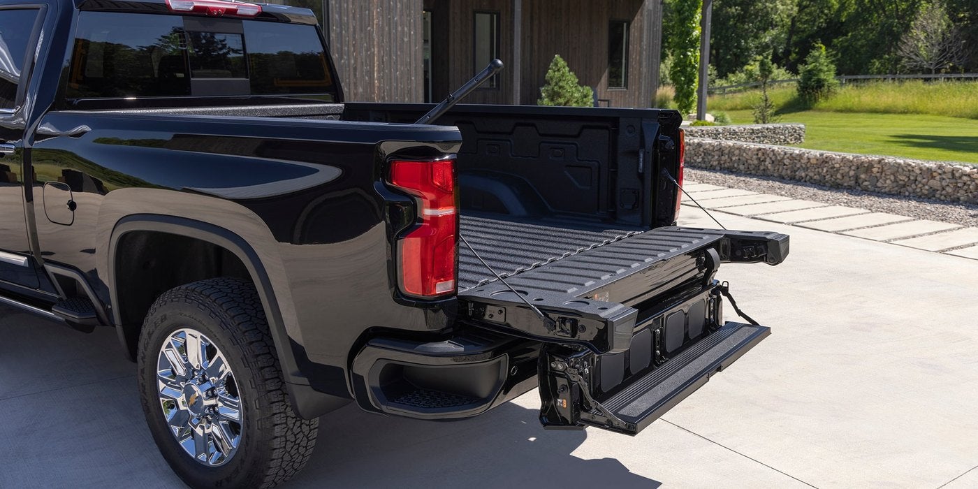 Rear corner of a black Silverado HD with the multi flex tailgate open