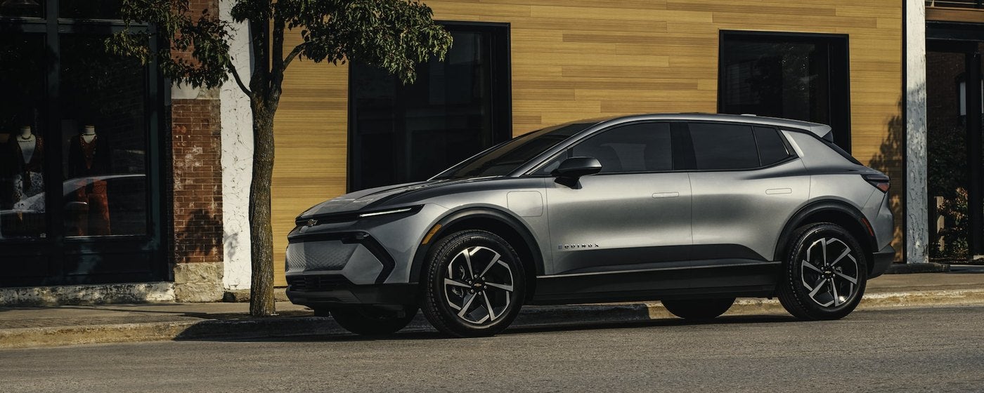 Gray Chevrolet electric SUV parked at the curb on a city street