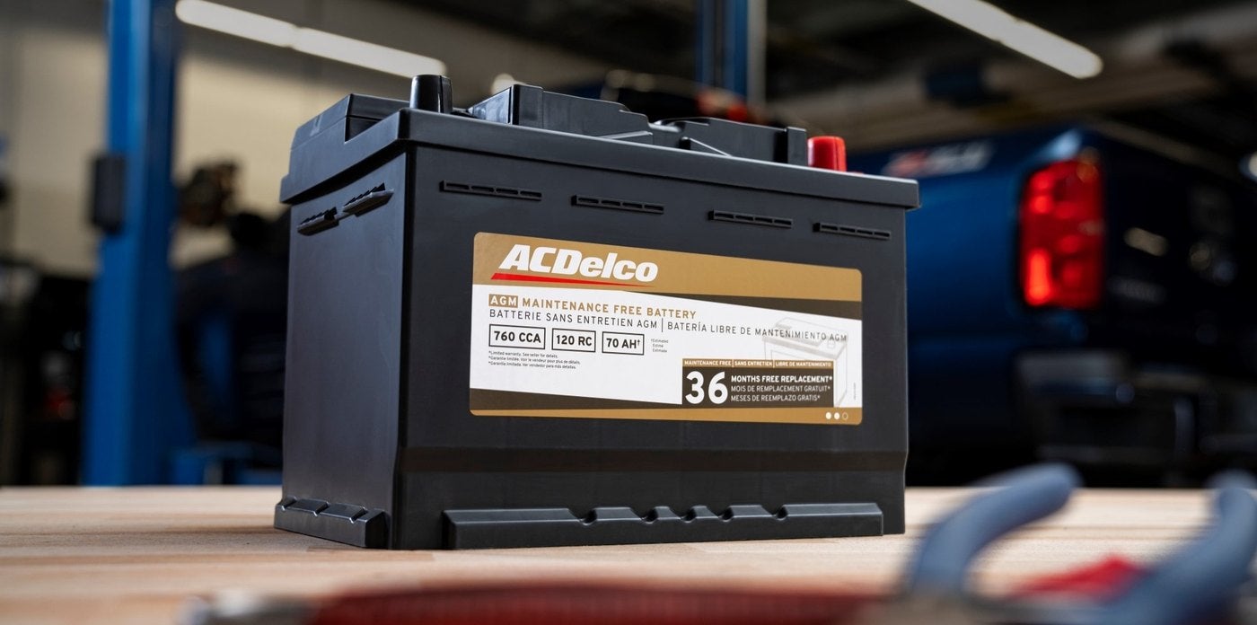 ACDelco maintenance free battery on a workbench in a Chevrolet service shop